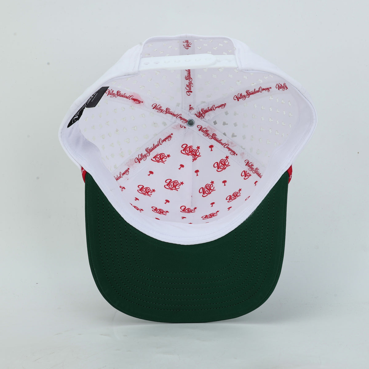 Tee Time Mexico White Rope Hat, underside view of the green bill and red printed interior taping